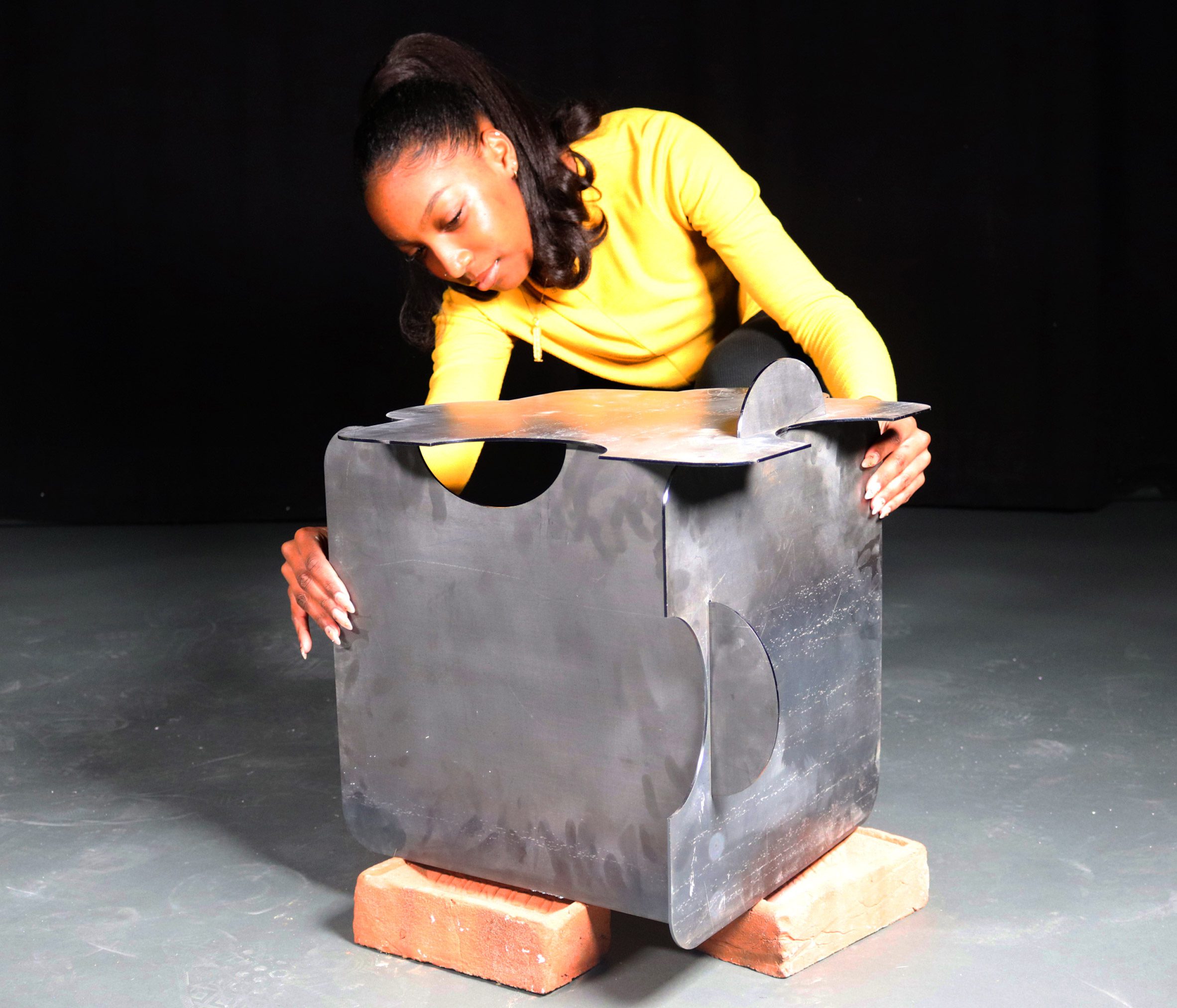 Person adjusting components of a steel table.