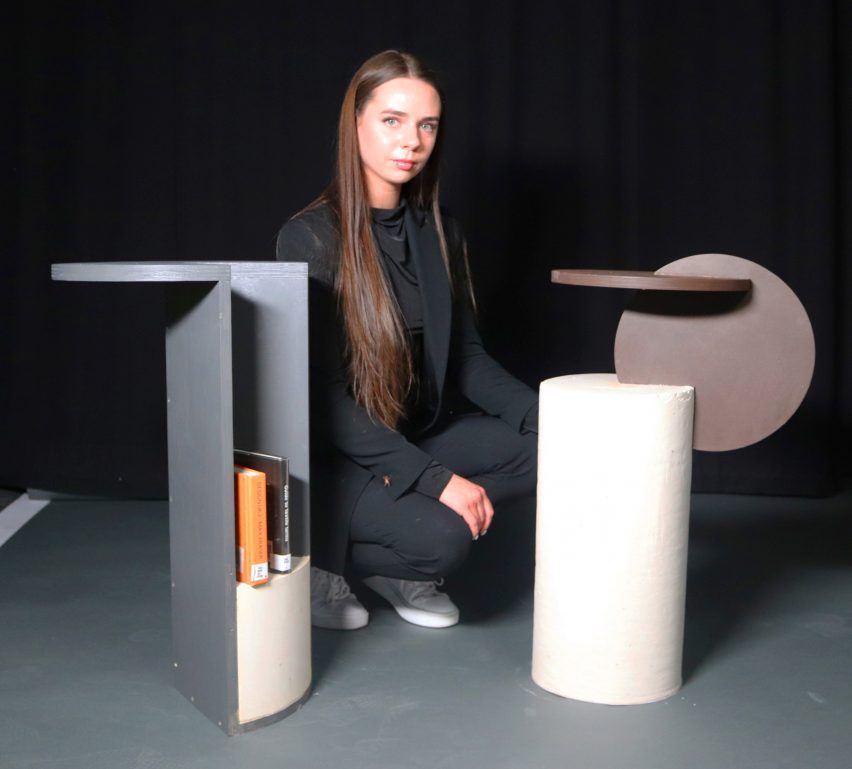 Person sitting next to a table series composed of circular shapes in grey, beige and brown.