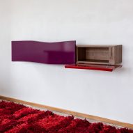 Shelving on wall with red carpet