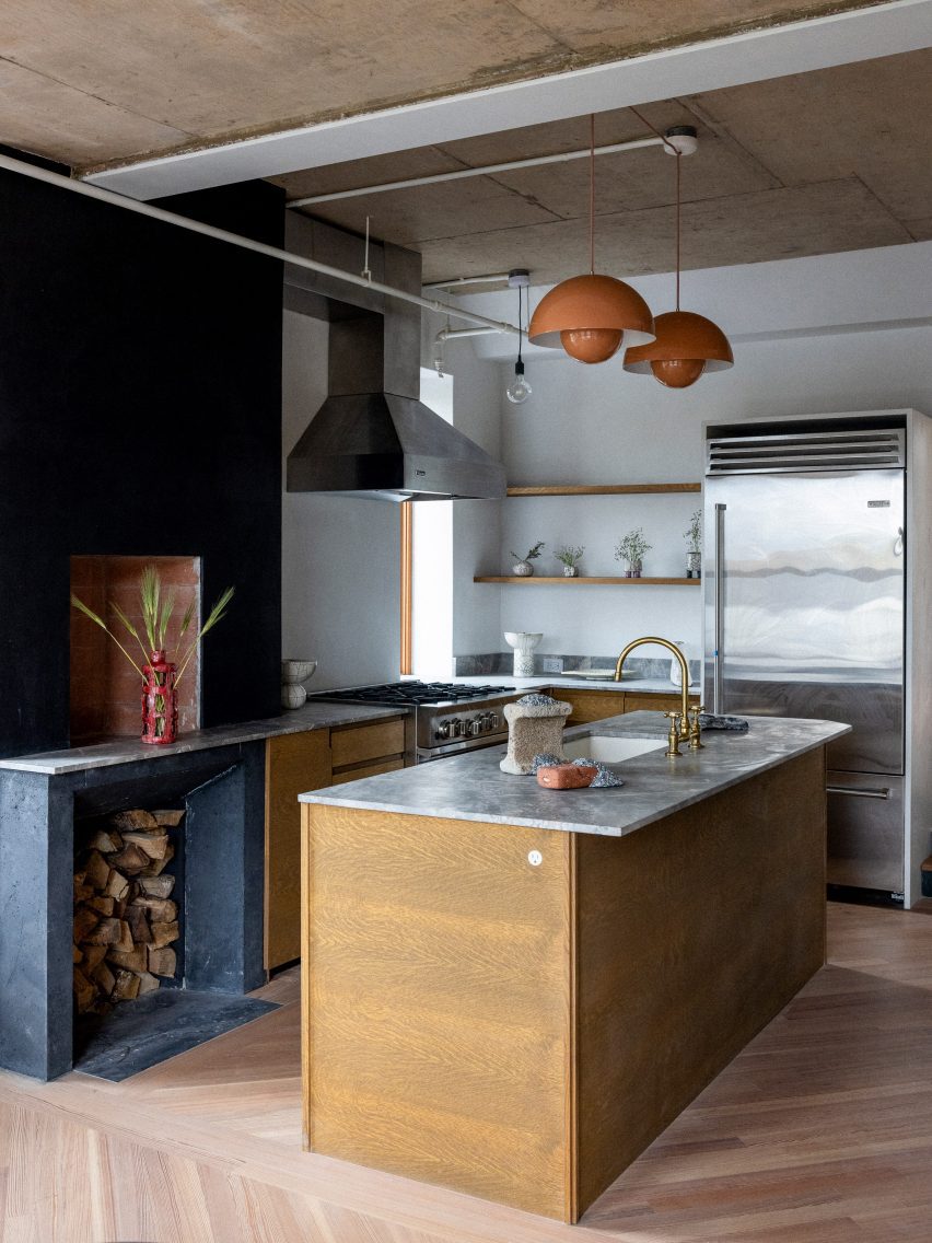 A kitchen with dark stone cladding