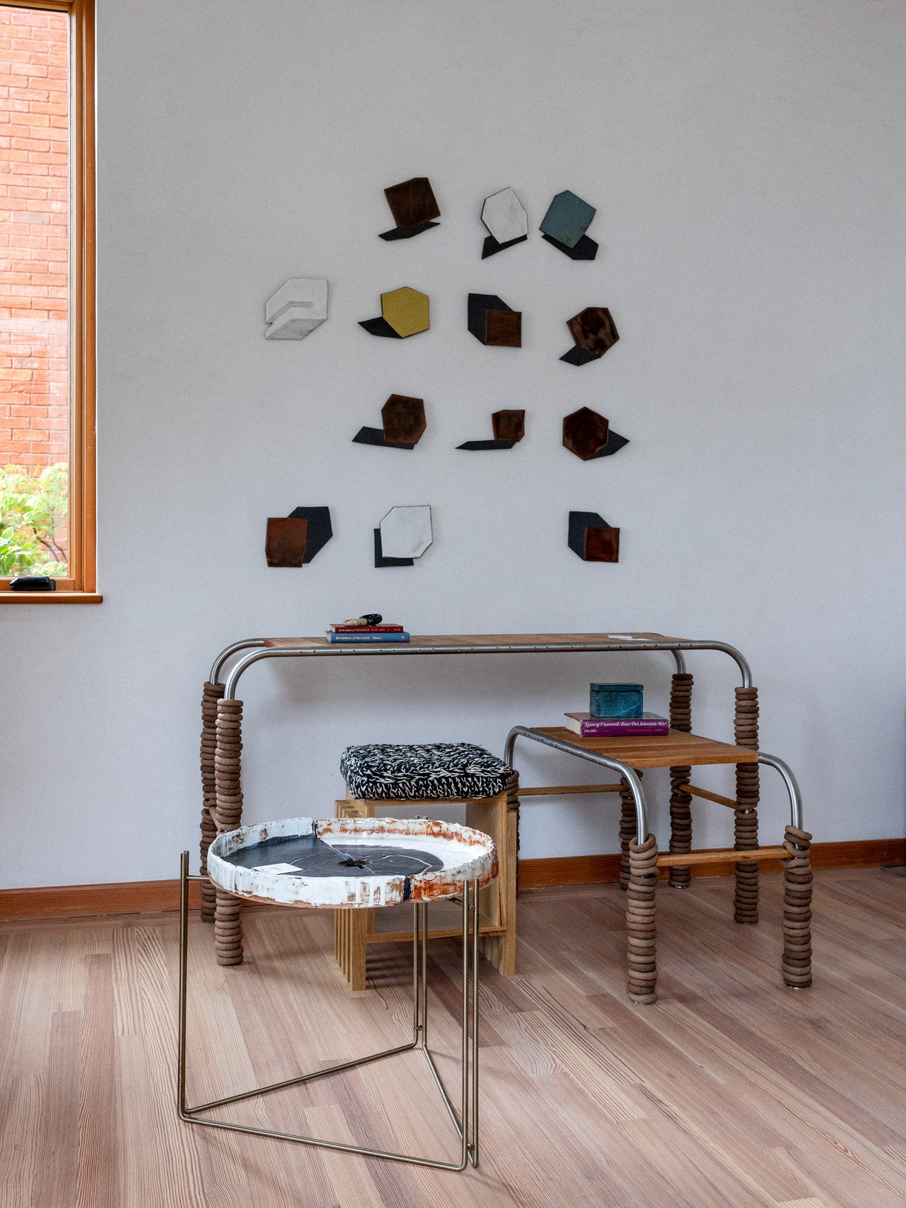 Tables and chairs in front of wall hanging