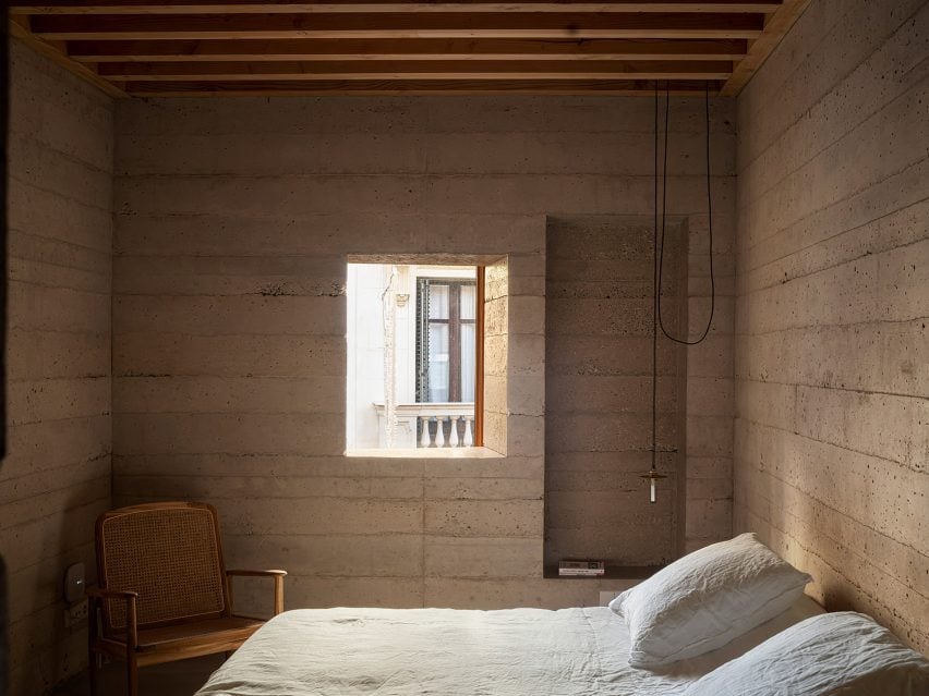 Bedroom interior within concrete home by H Arquitectes