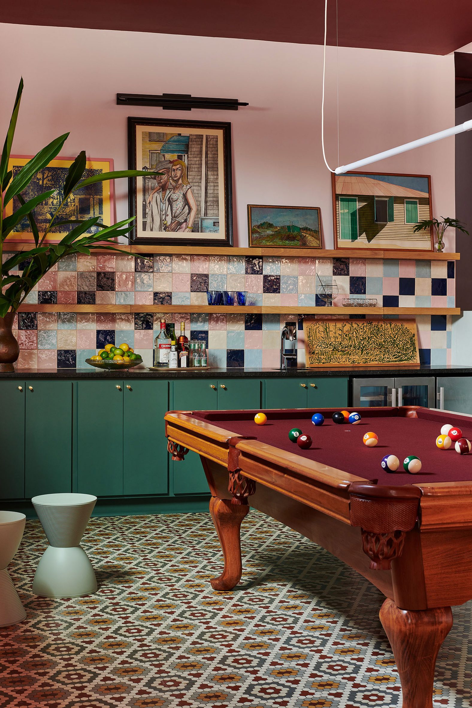 Home interior with penny-hex floor tiles and an oxblood-toned pool table