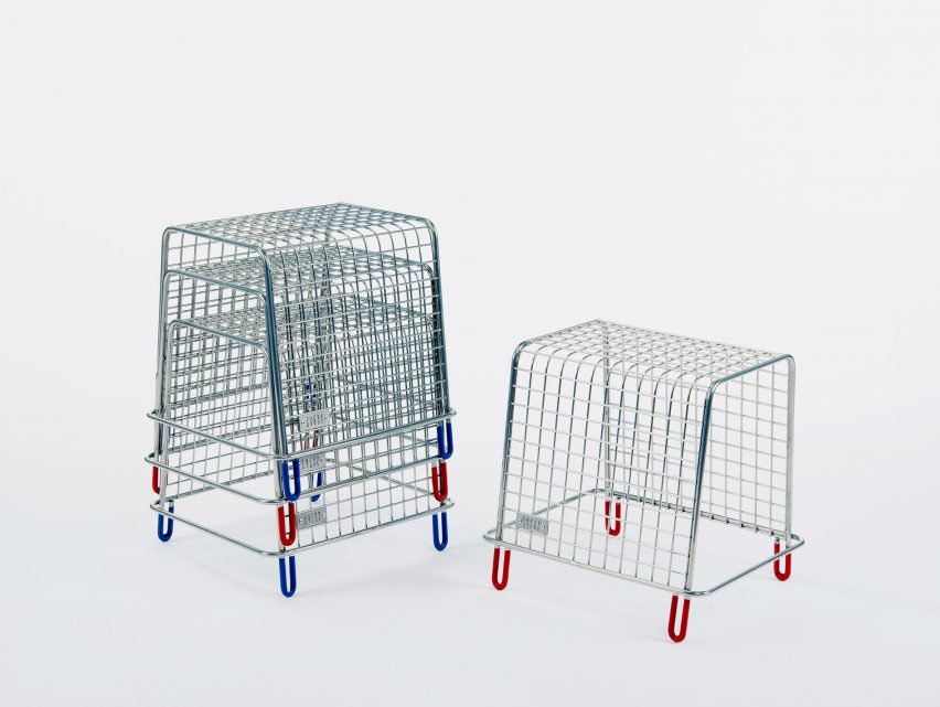 A photograph of silver metal stools with blue and red legs, three are stacked on top one another and one stands alone next to them.