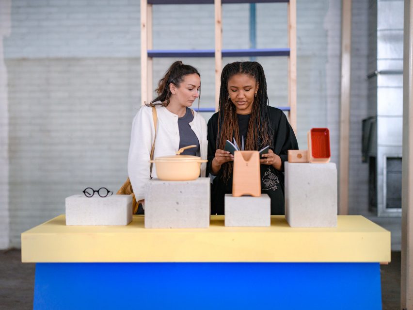 Promotional photo for Dundee Design Festival showing two women looking at objects on a display table