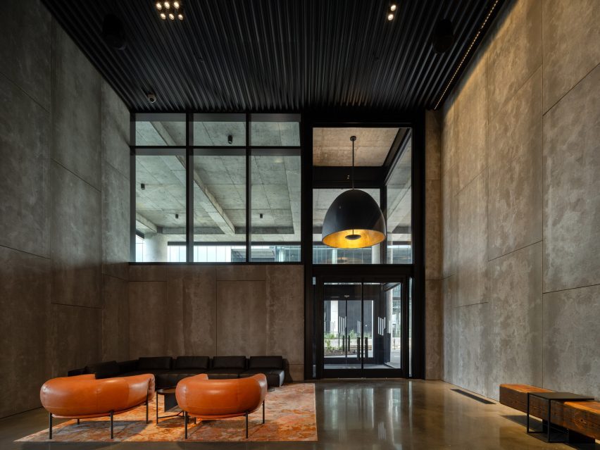 Concrete interior of office building by Olson Kundig