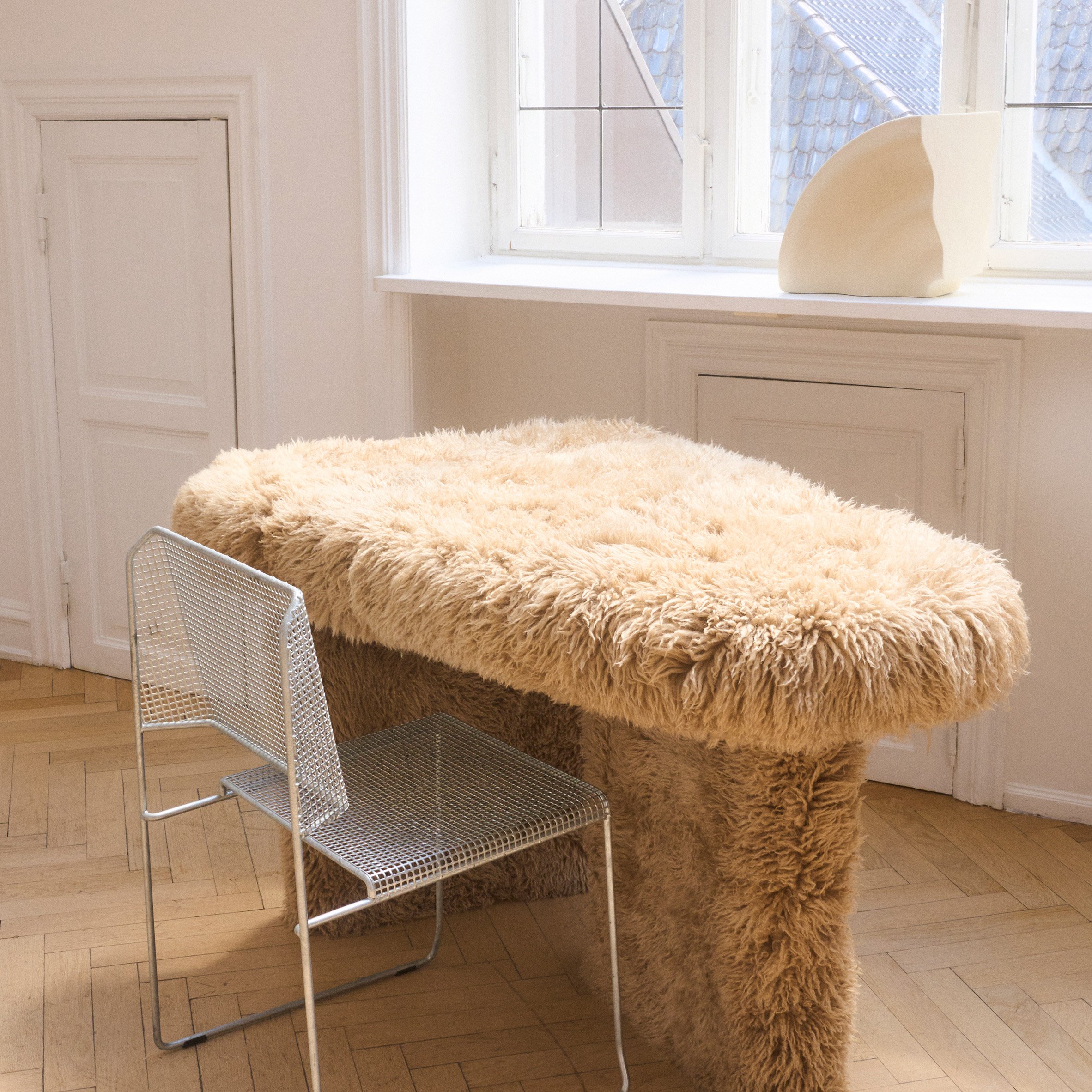 Studio Kasa Kasa's fur-covered desk and a bent aluminium chair by Carlberg Design