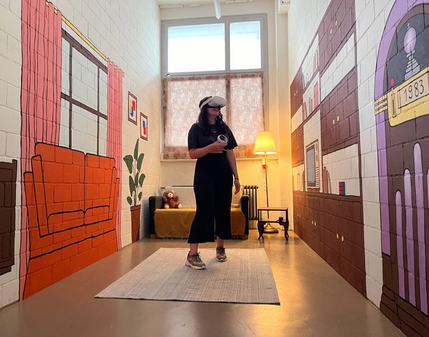 A photograph of a person wearing a virtual headset in a room with various objects painted on the walls in tones of orange, purple and brown.