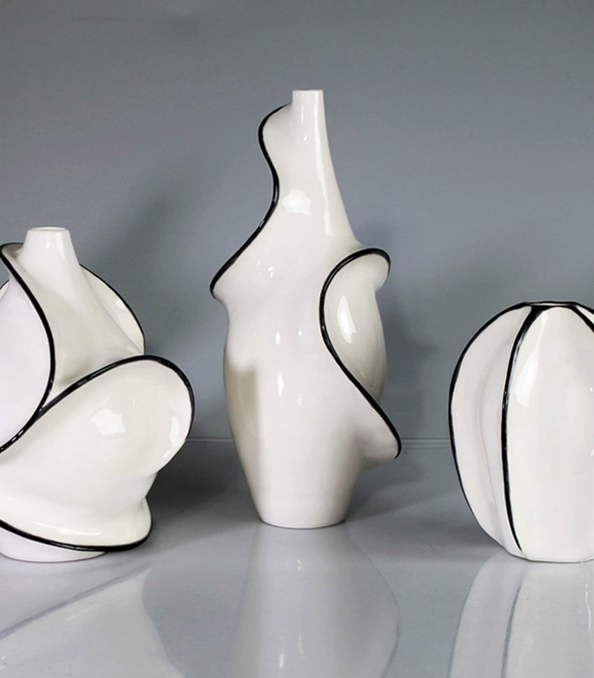A photograph of three ceramic objects in colours of white and black, against a grey backdrop.