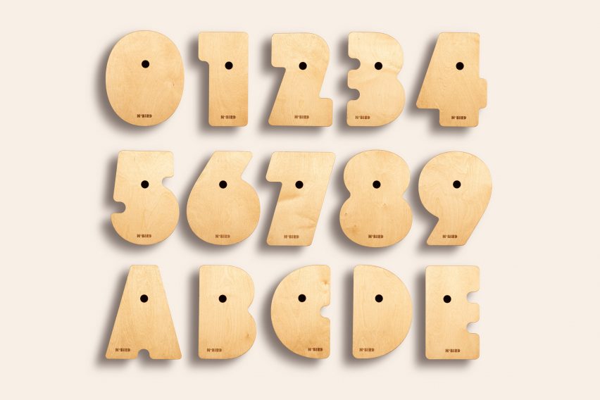 A photograph of wooden numbers of zero to nine, with wooden letters of a to e, against a white background.