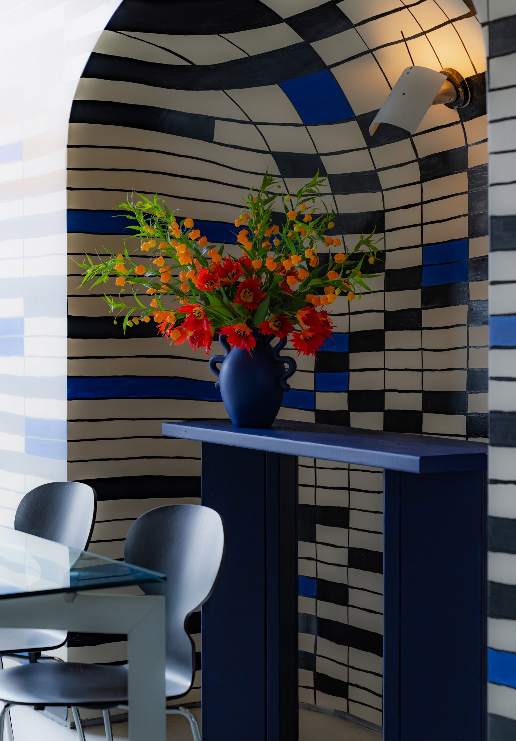 Private dining space decorated with a mural inspired by the Bauhaus abstract grid