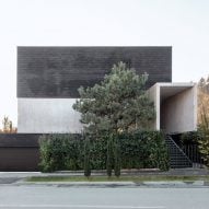 OFIS Arhitekti marries exposed concrete with black brick for Slovenian home