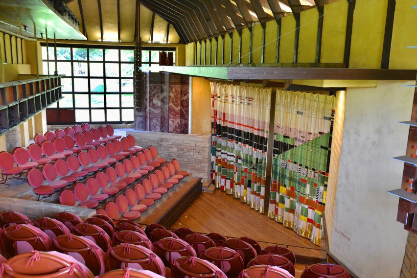 Theatre with colourful curtain and red seats