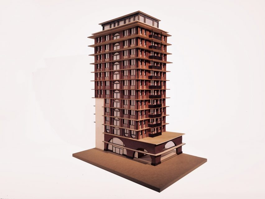A photograph of an architectural model in tones of brown, against a white backdrop.