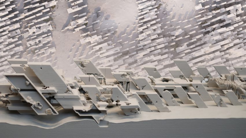 A close up photograph of an architectural model in tones of white and grey.