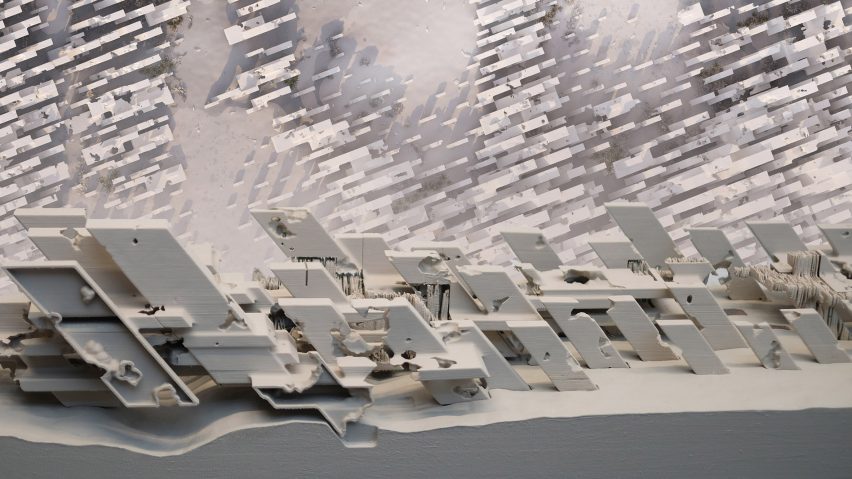 A close up photograph of an architectural model in tones of white and grey.