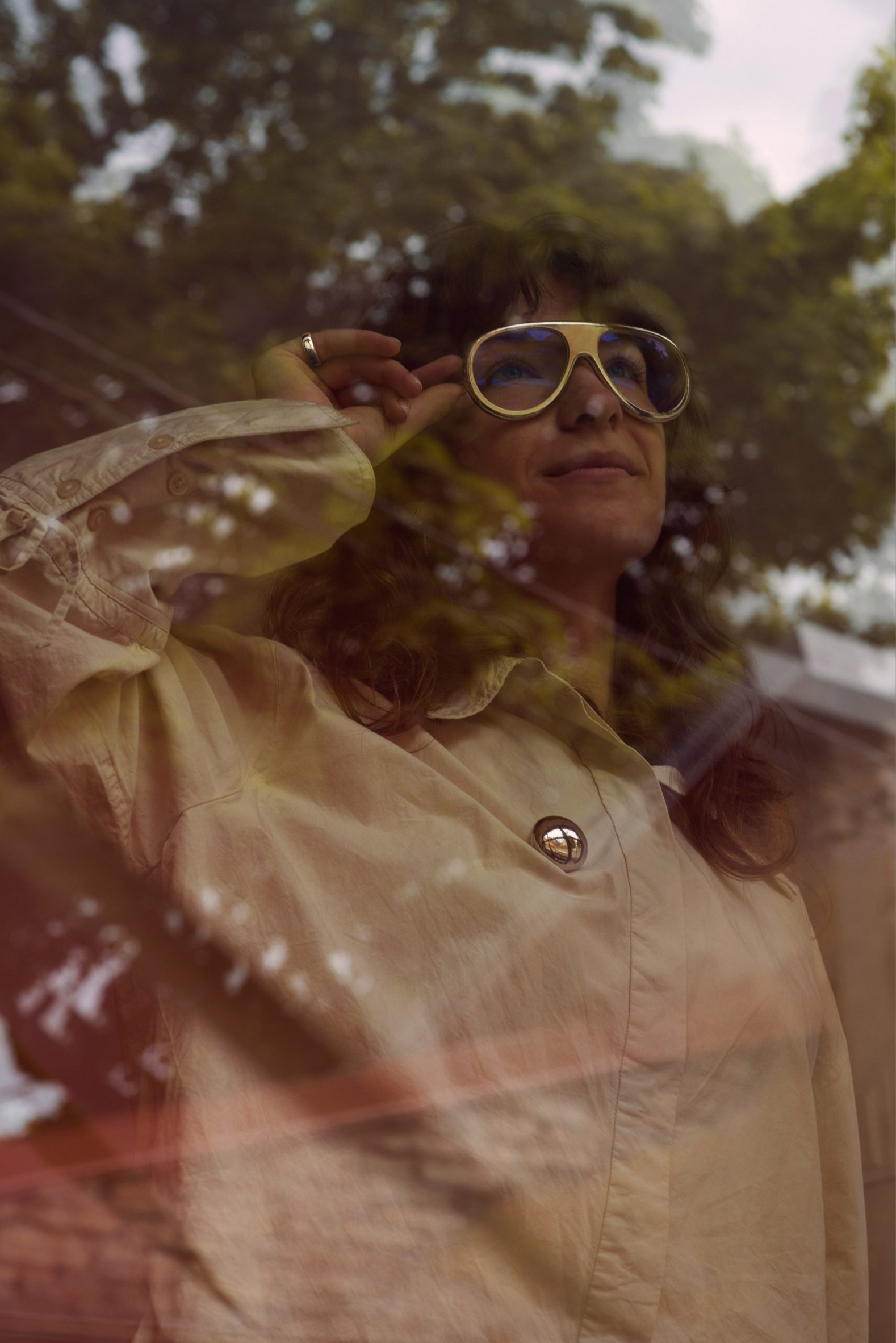 Person wearing glasses looking through a window