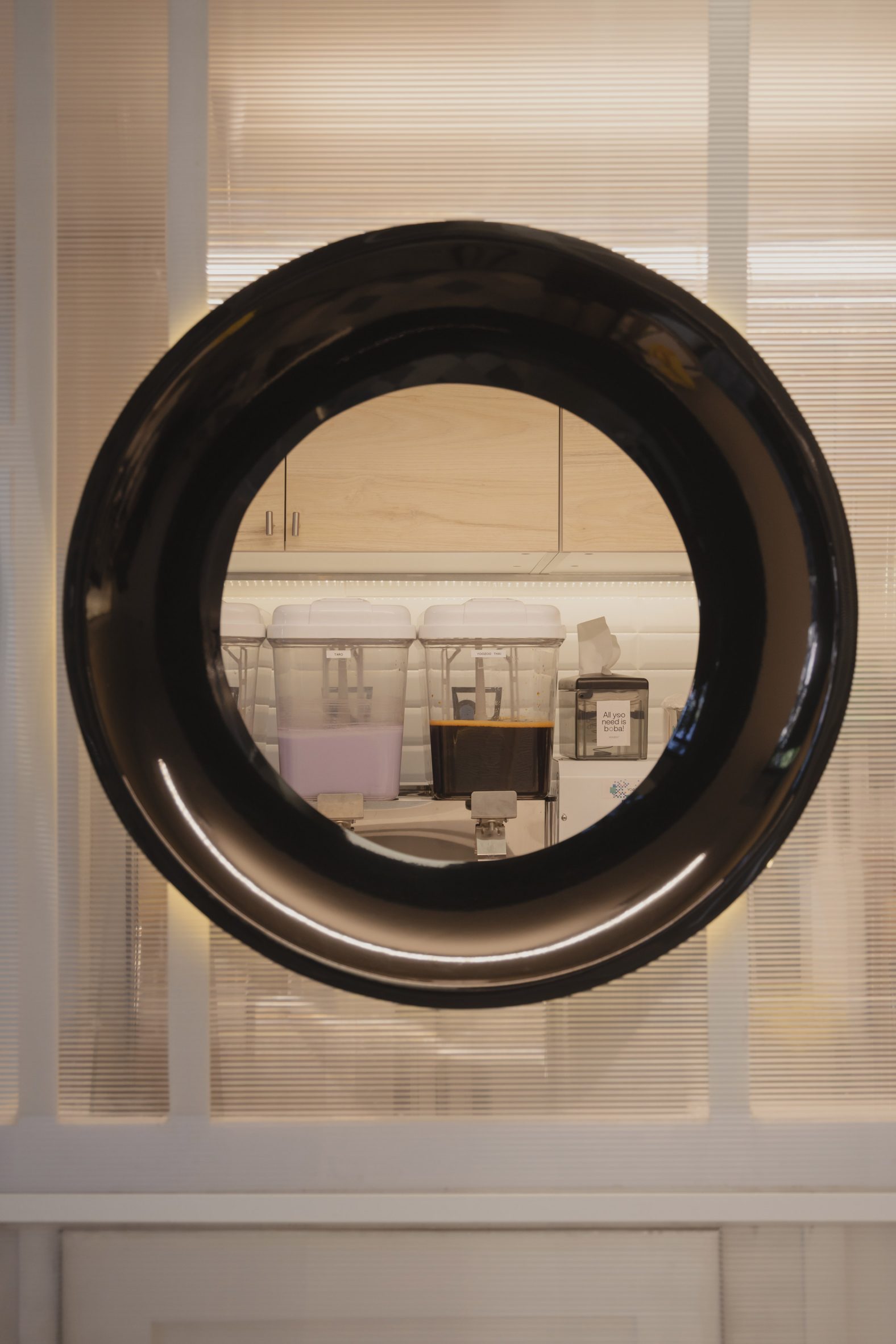 Black-ringed porthole with view of boba tea prep area