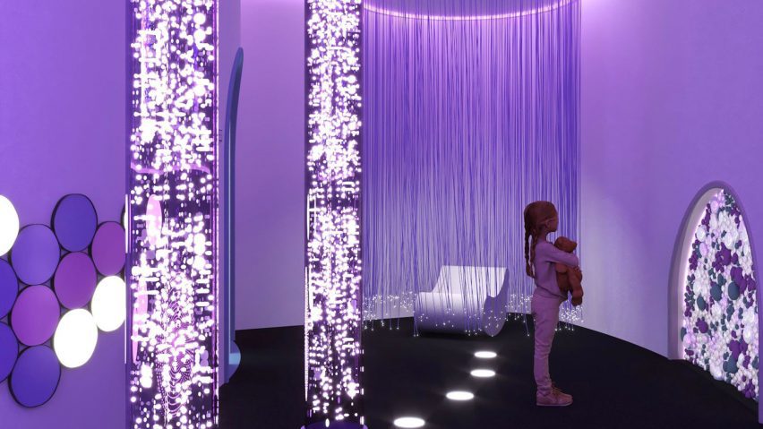 Child standing in a purple room