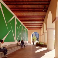 A large green mural underneath a loggia