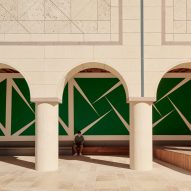 A large green mural underneath a loggia