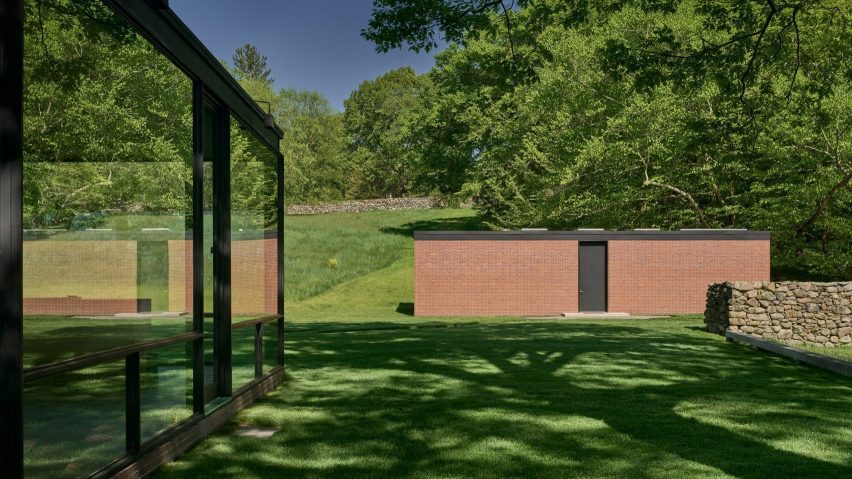 Brick outhouse besides glass house