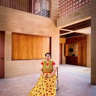 A woman sitting in the centre of an empty building