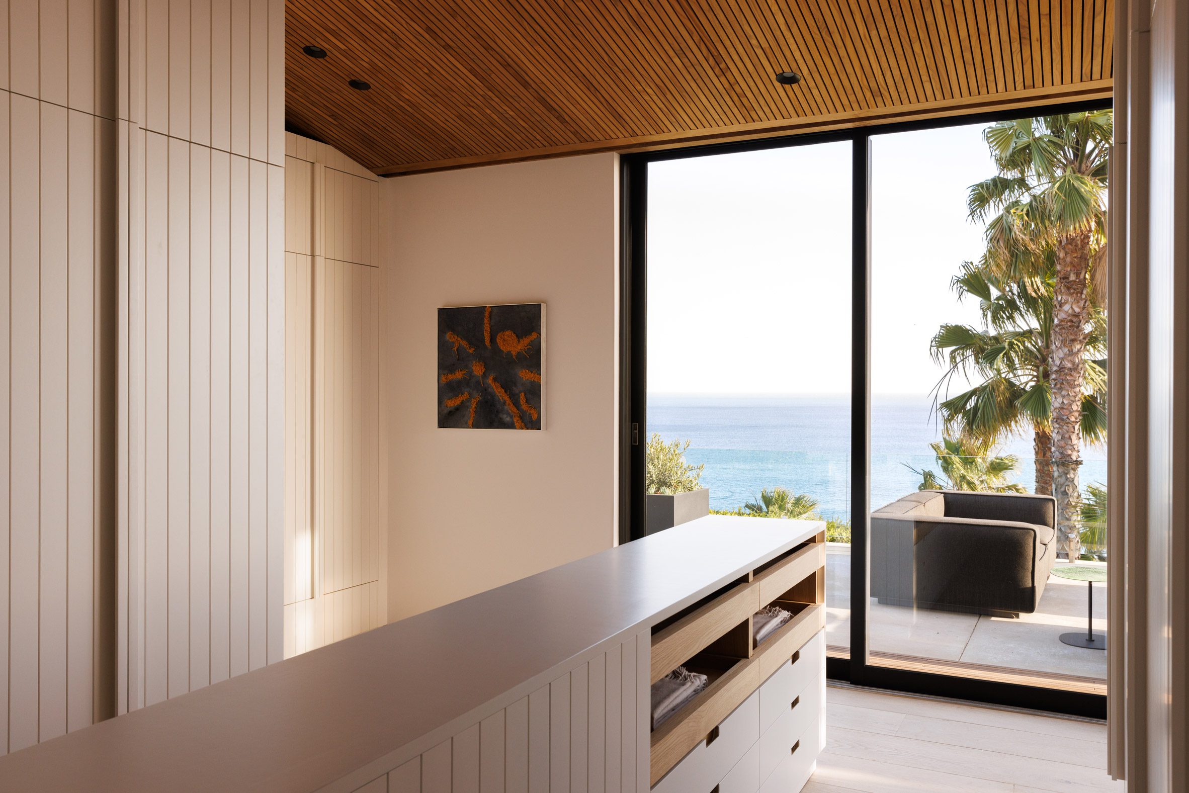 Dressing room with white millwork and ocean view