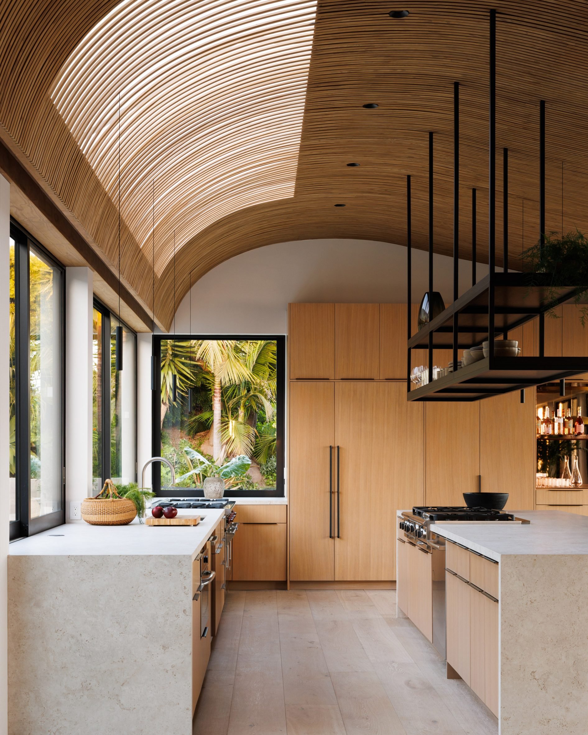 Kitchen with neutral decor and a wave-like wooden ceiling