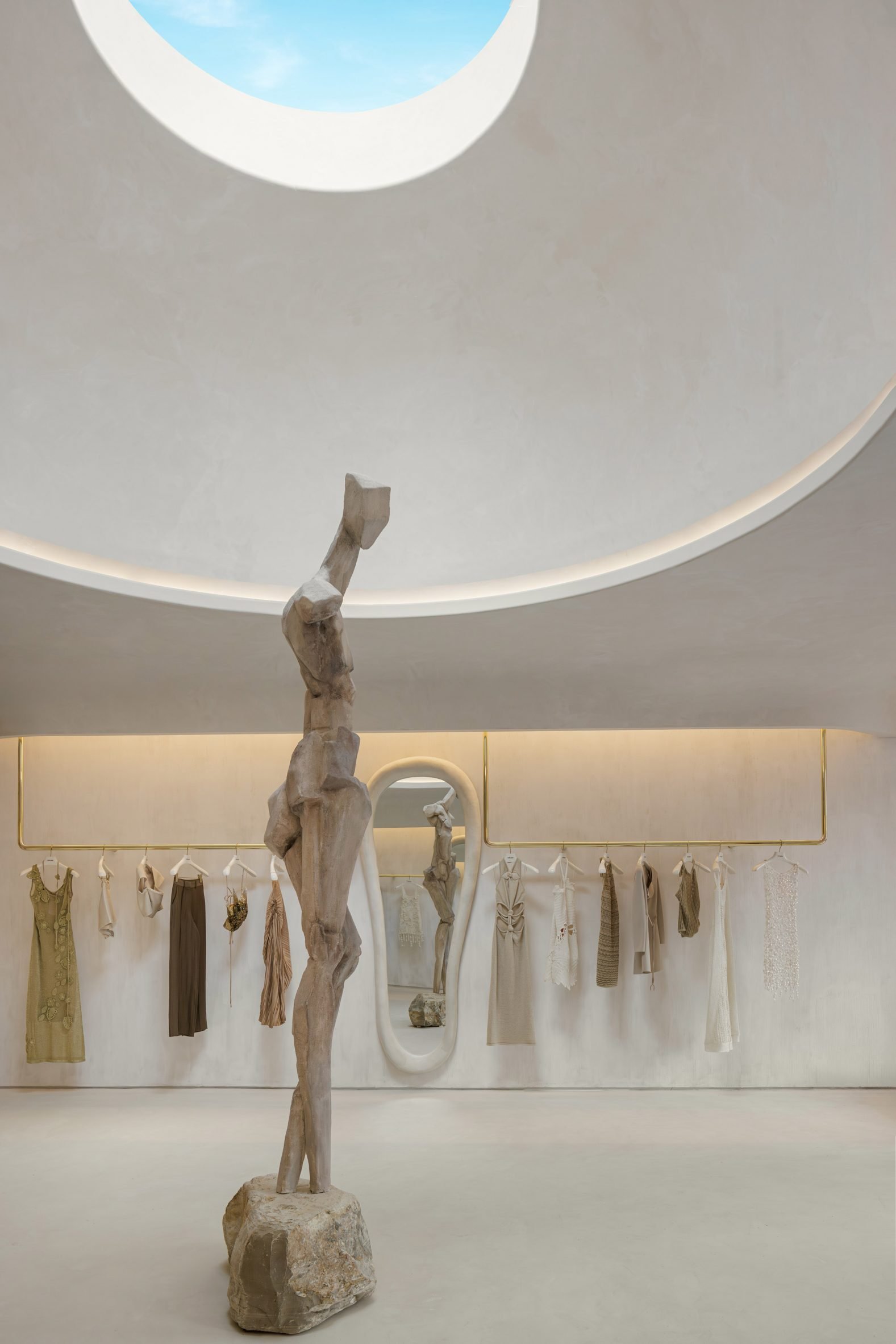 12-foot sculpture of the Greek goddess Gaia standing below an oculus