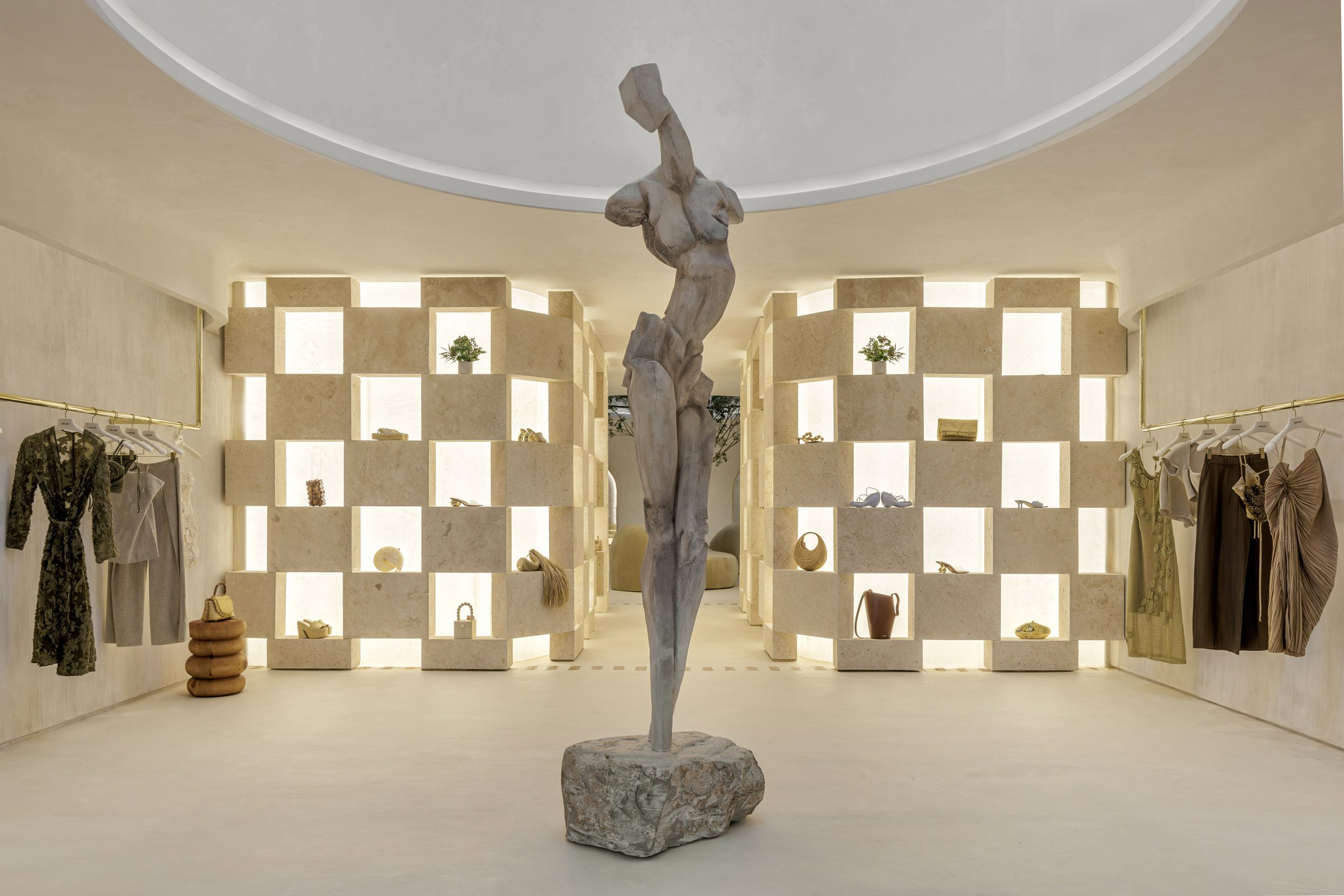 Concrete sculpture in the centre of a neutral-toned boutique