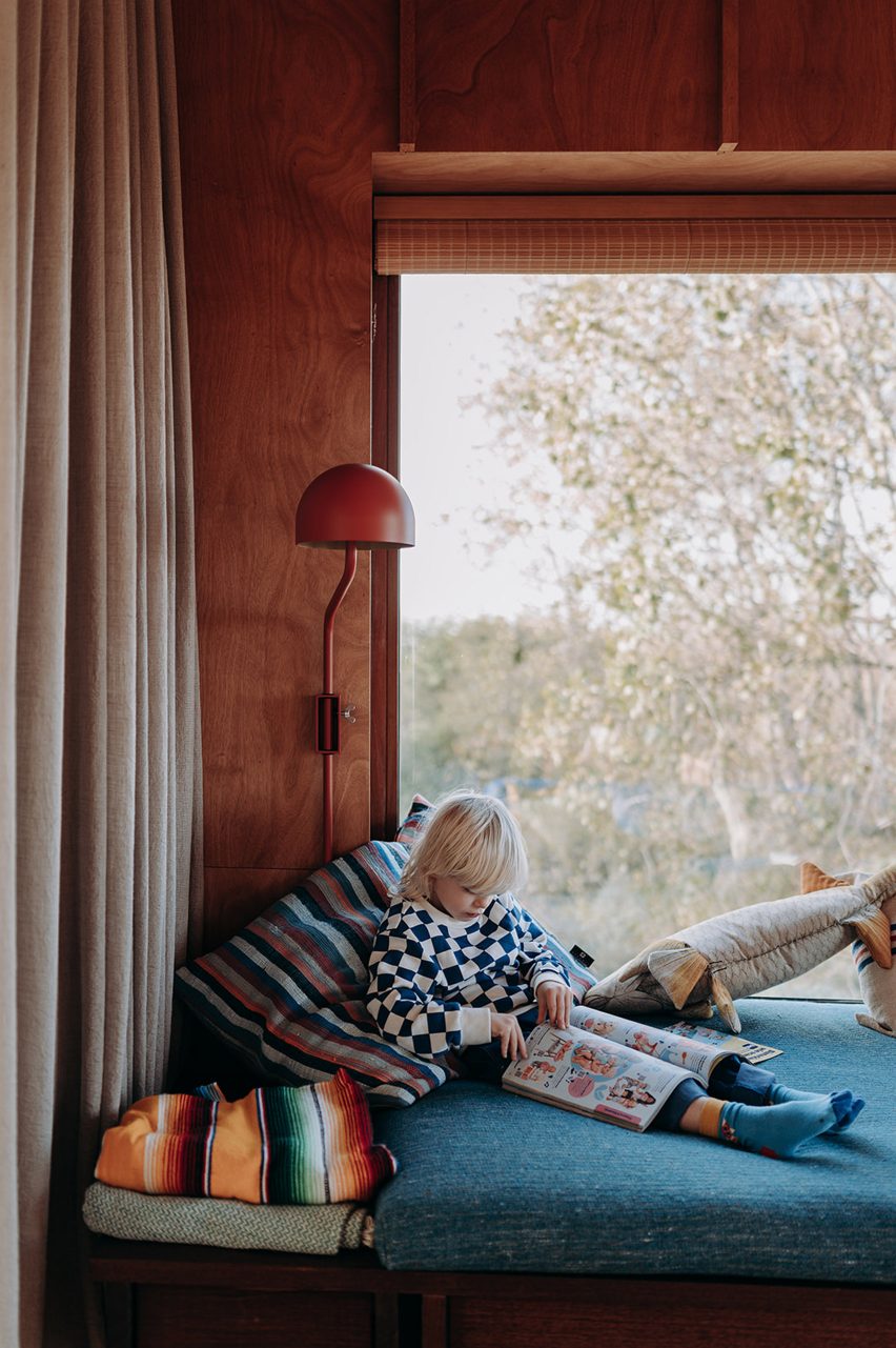 Child reading on a window seat