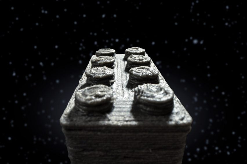 Composite image showing a close-up of a 3D-printed Lego-style brick appearing to fly through space