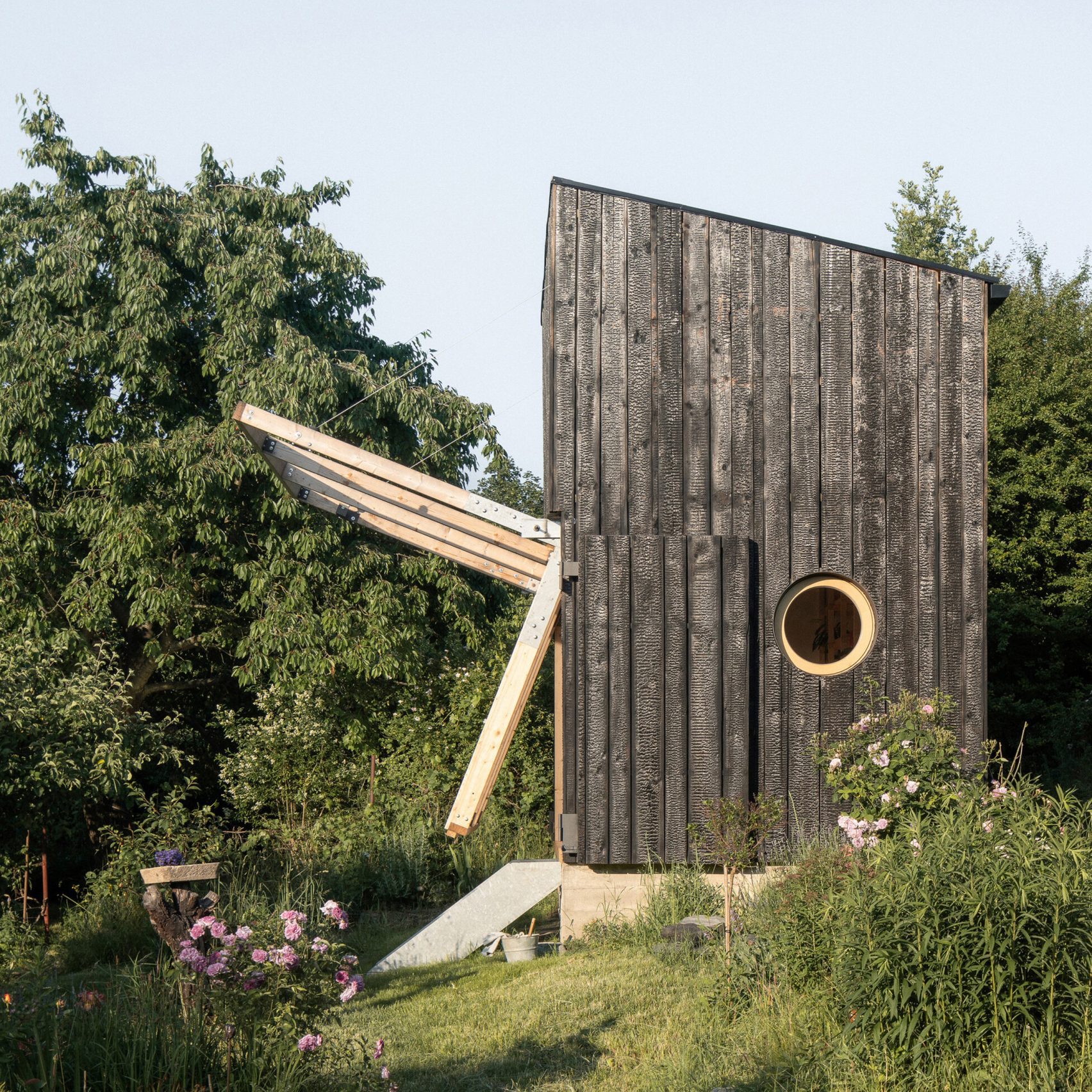 Byró Architekti creates wooden garden pavilion with folding facade ...
