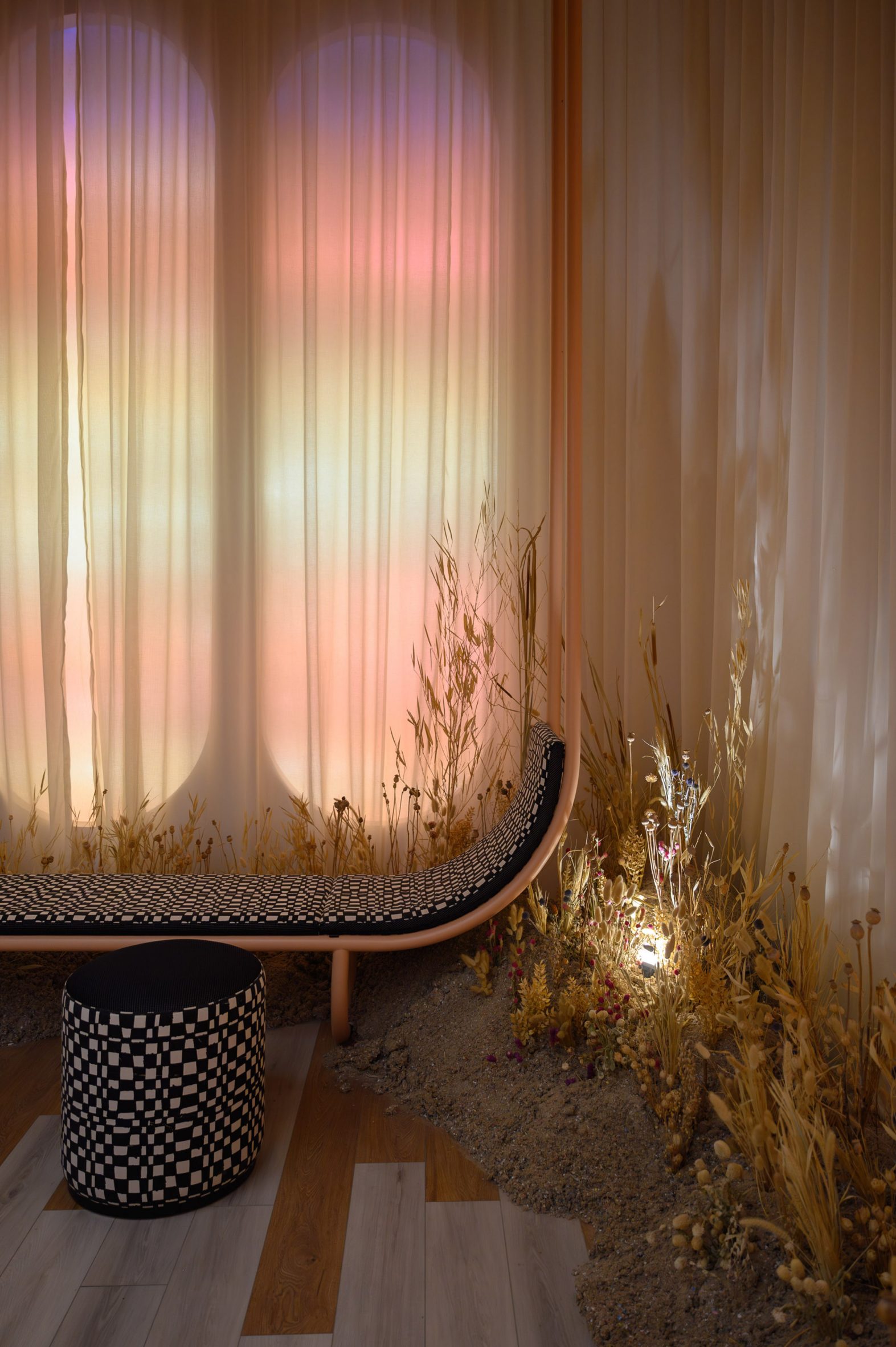 Panels illuminated to mimic a sunset installed behind translucent curtains