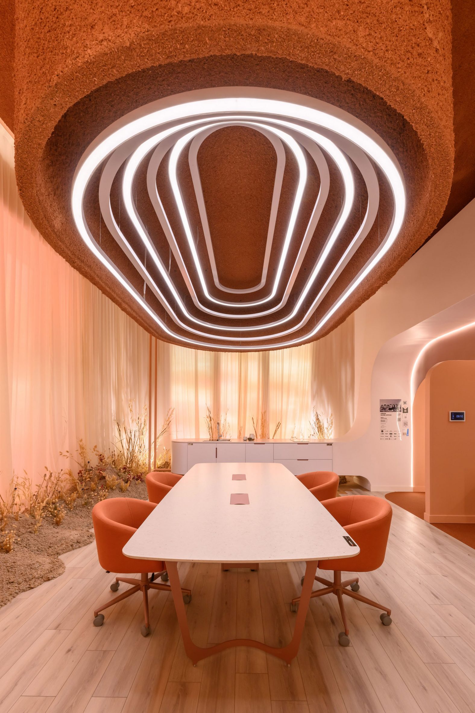 Light fixture with rings of LEDs inside suspended over a dining or meeting table