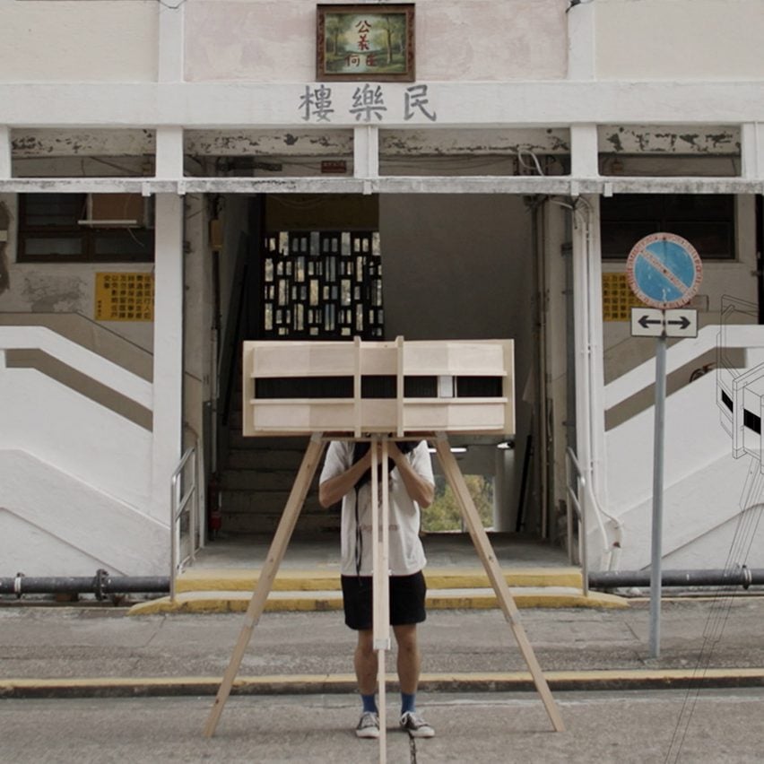 A photograph of a photographic device placed in front of a white building