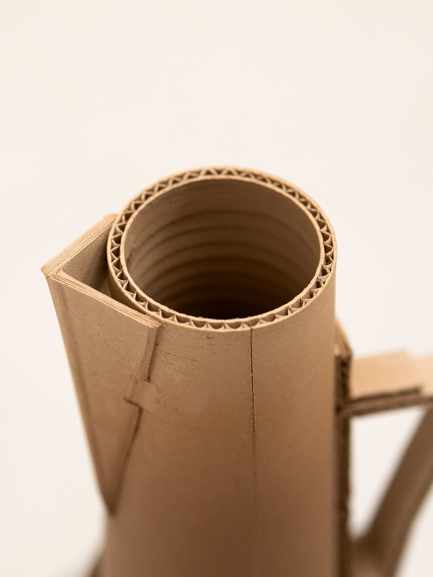 A photograph from above of a ceramic brown vase against a white background.