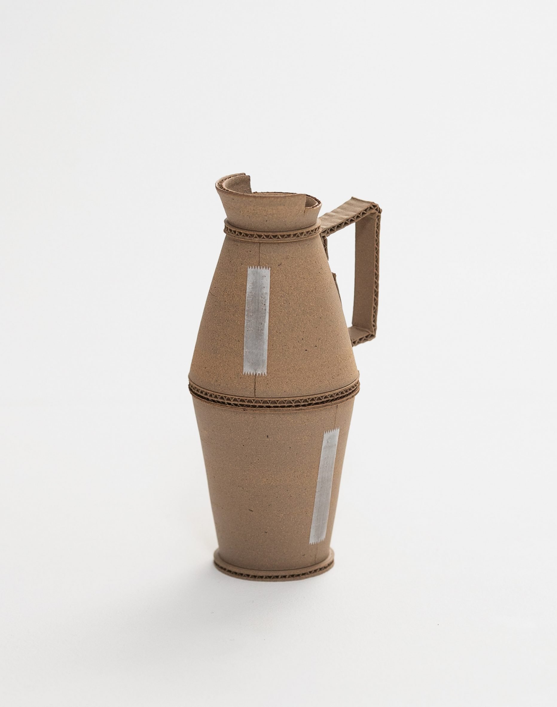 A photograph of a brown jug against a white background.