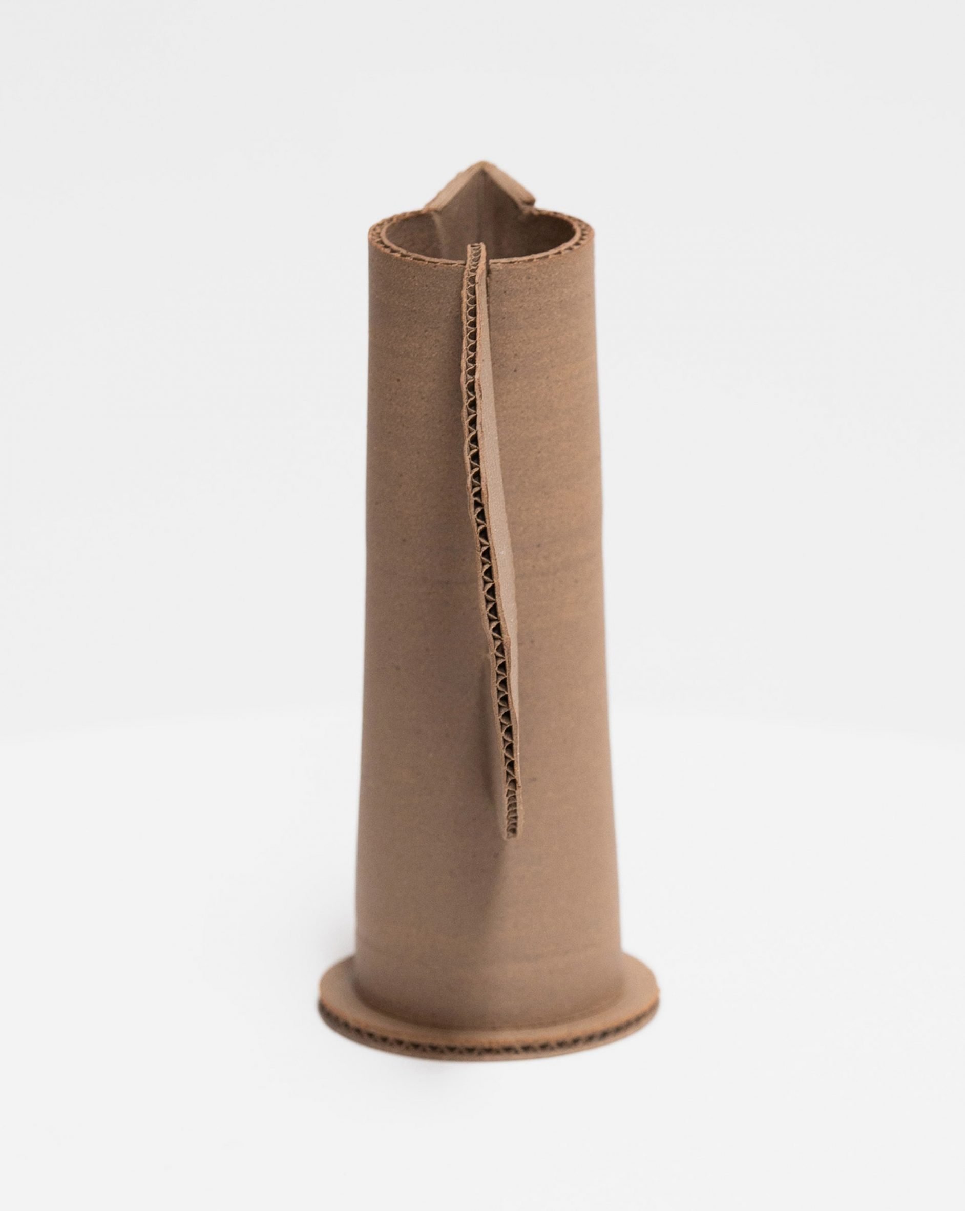 A photograph of a brown vase against a white background.