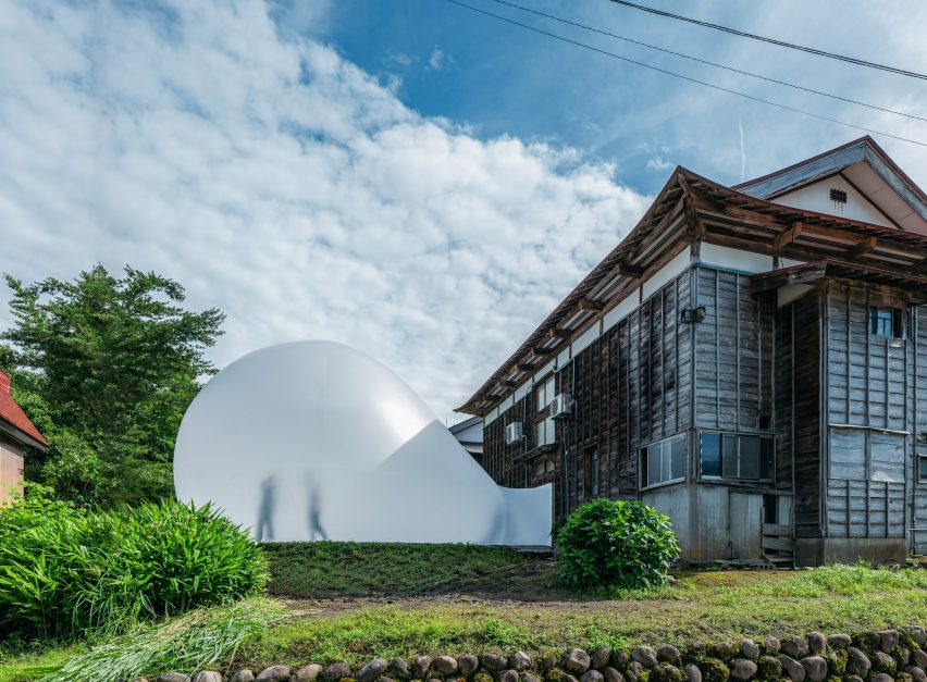 Wooden house with bubble art installation