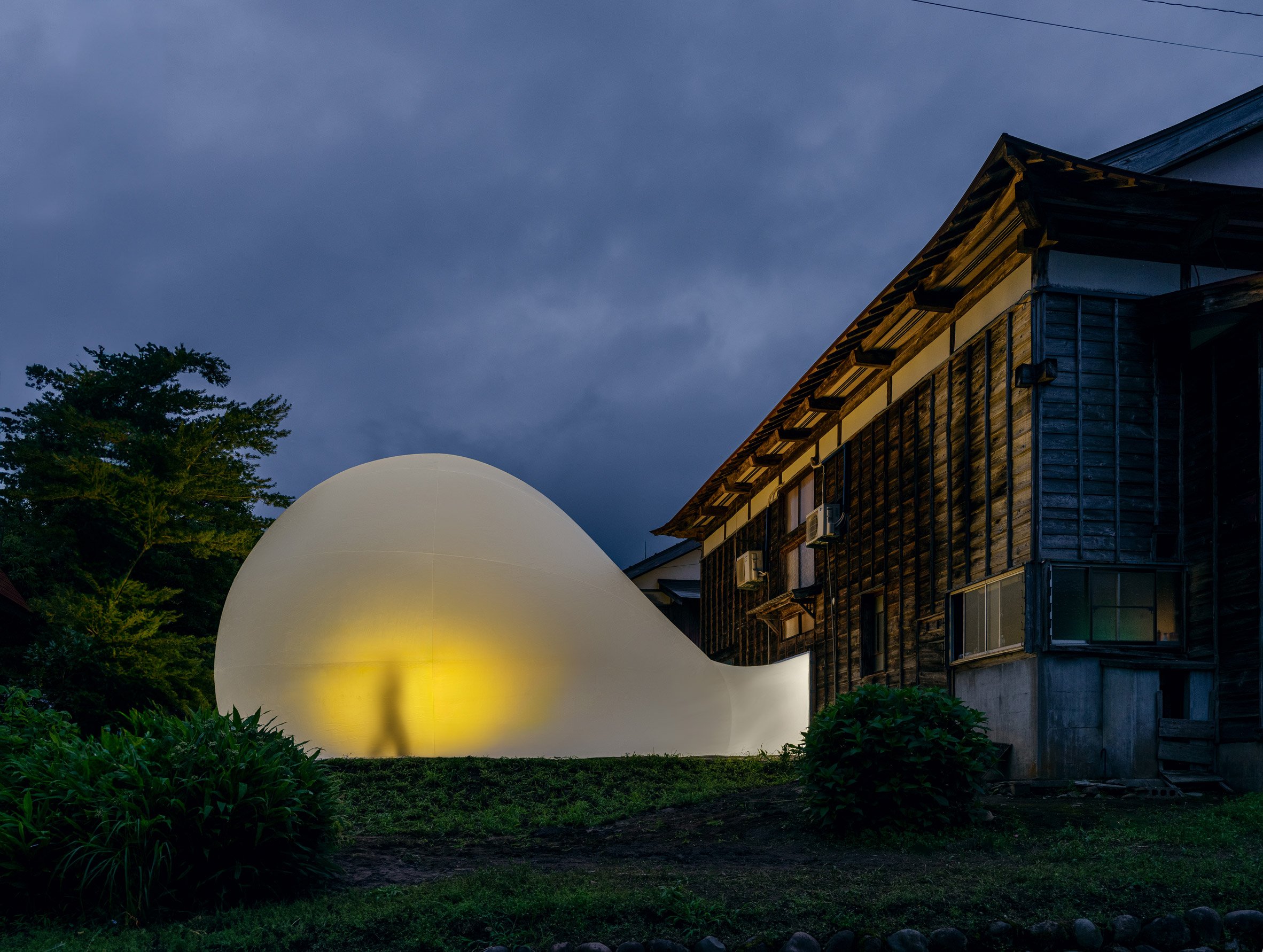 A giant lit-up bubble outside a Japanese house