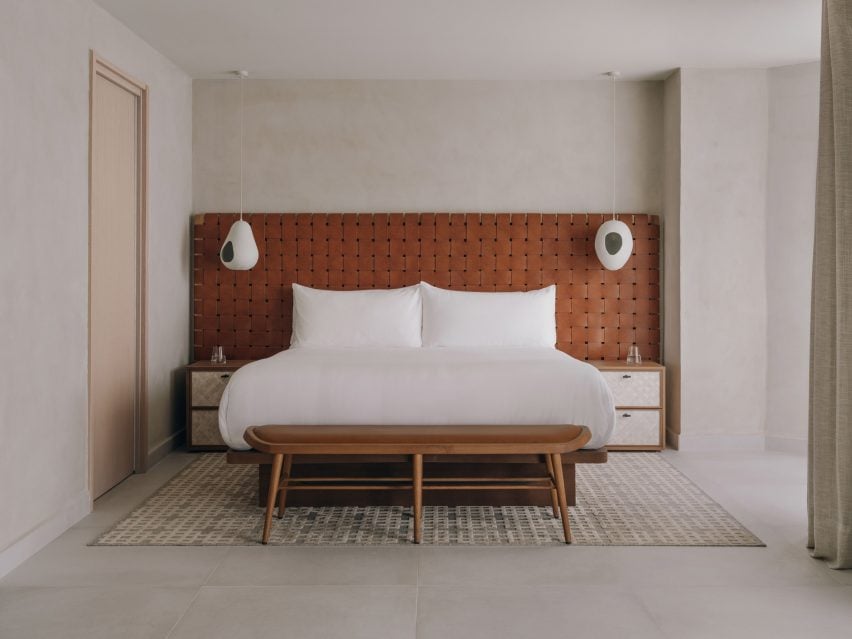 Bedroom with textured plaster walls and woven leather headboard