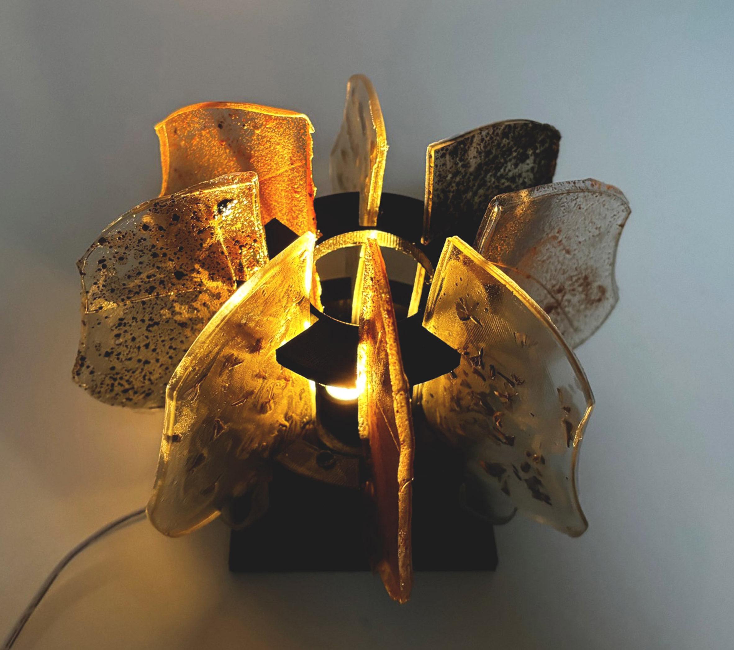 A photograph of a lamp made from bioplastics in tones of brown