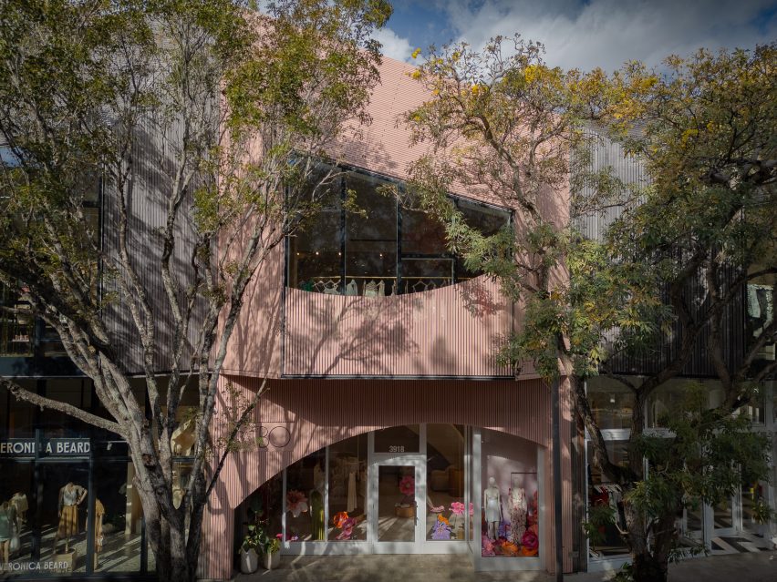 Store exterior wrapped in pale pink wood slats