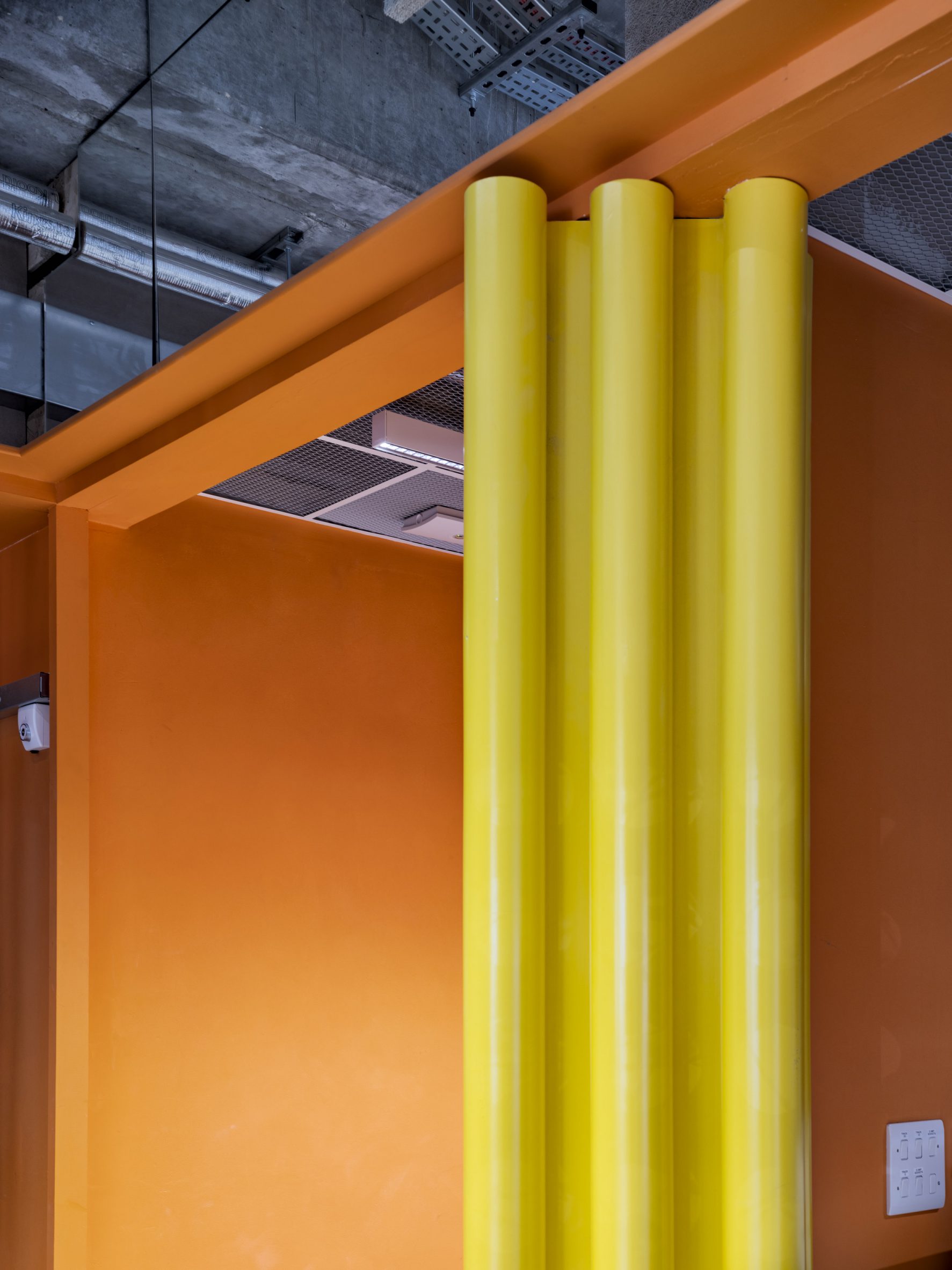 Close-up of pivoting wall section in orange and yellow