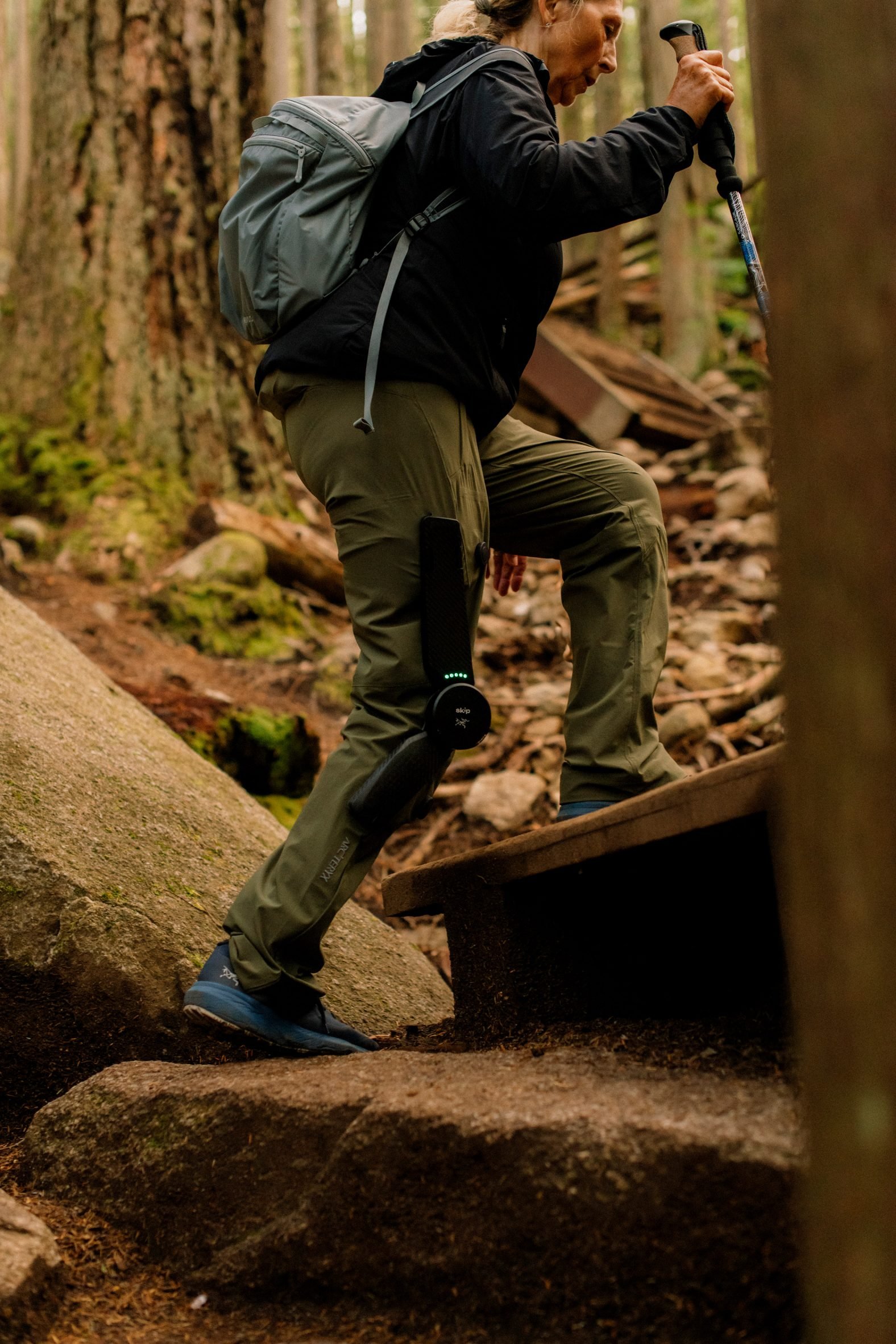 Side view of woman hiking up a step