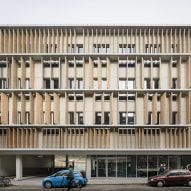 EVR Architecten wraps office in Belgium with movable wooden louvers