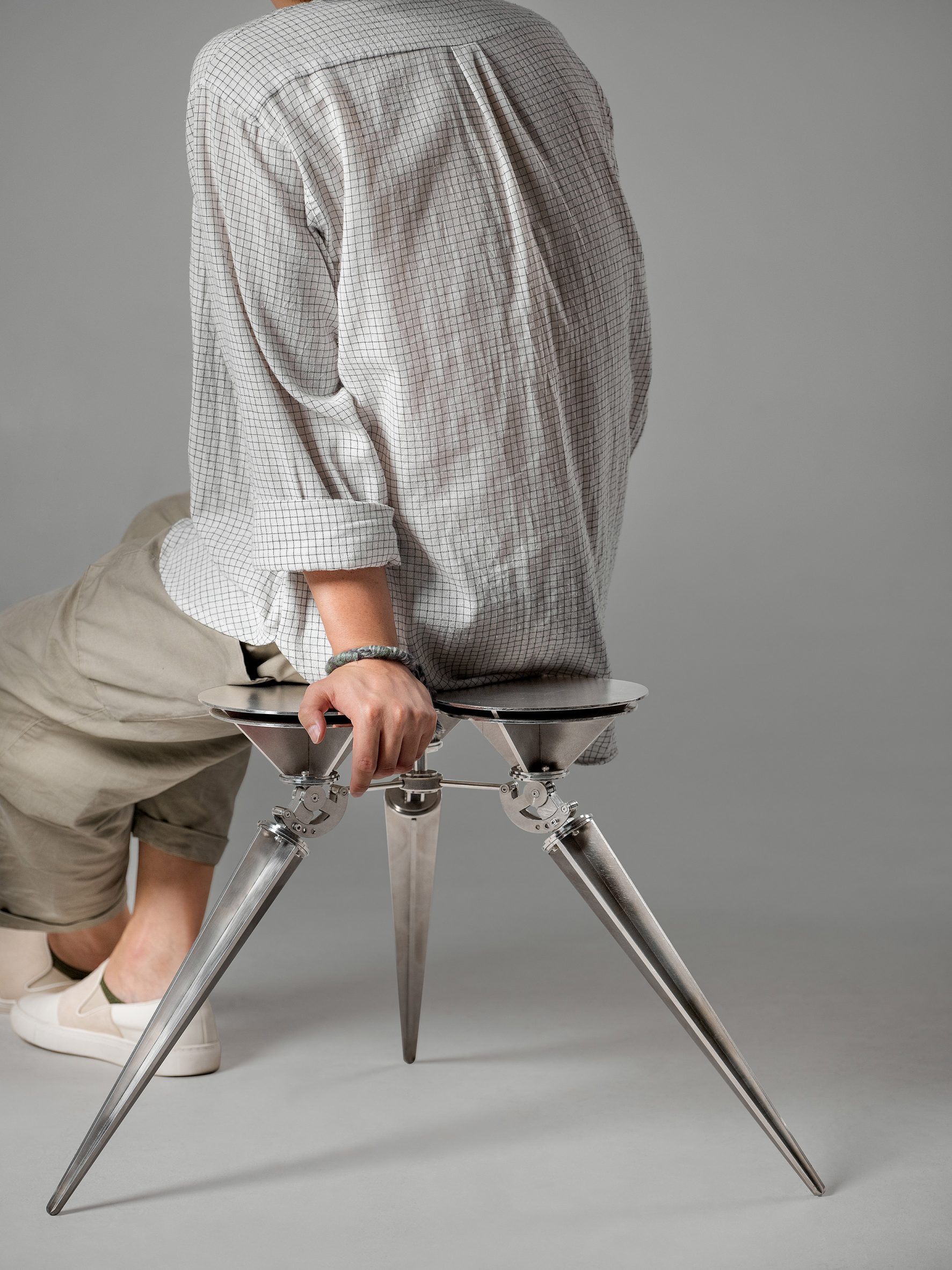 Person sitting on Chul-02 Cone Stool