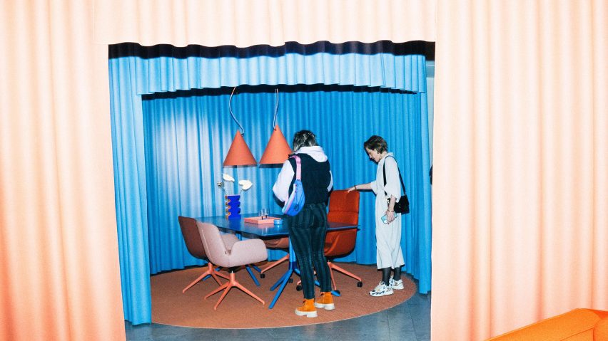 Visitors in blue curtained room